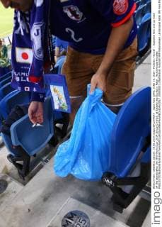 Japan fans (JPN), JUNE 19, 2014 - Football Soccer : Japanese fans pick up trash off the stands after the FIFA World Cup 2014 Group C match at Estadio das Dunas in Natal . Noxthirdxpartyxsales  (00000001 pfta006165)