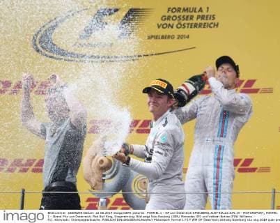 FORMEL 1 - GP von Österreich SPIELBERG,AUSTRIA,22.JUN.14 - MOTORSPORT, FORMEL 1 - Grand Prix von Österreich, Red Bull Ring, Siegerehrung. Bild zeigt Nico Rosberg (GER Mercedes GP) und Valtteri Bottas (FIN Williams F1). Keywords: Champagnerdusche. 