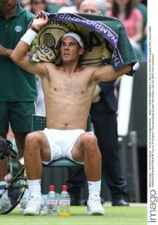 Spain s Rafael Nadal takes a rest during his men s singles first round match 
