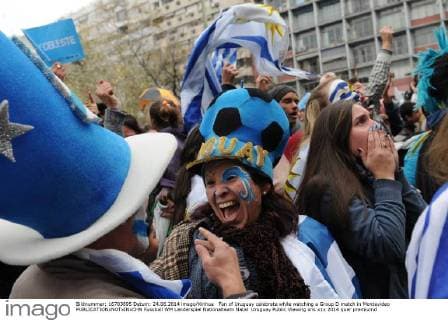 Fan of Uruguay celebrate while watching a Group D match in Montevideo 