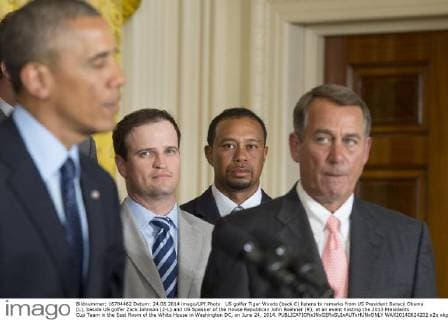 US golfer Tiger Woods (back C) listens to remarks from US President Barack Obama (L), beside US golfer Zack Johnson (2-L) and US Speaker of the House Republican John Boehner (R), at an event hosting the 2013 Presidents Cup Team in the East Room of the White House in Washington DC, on June 24, 2014.  WAX20140624202