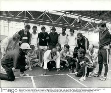 May 05, 1972 - Jesse showing them how.: Jesse Owens, who won 4 gold medals at the 1936 Olympic games in Berlin, is now in Munich to look over the Olympic site. Now 58, Jesse is seen here showing German athletes how he used to get sway to a good start.  - ZUMAk09