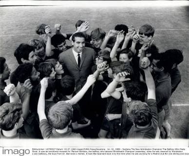 Jul. 02, 1966 - Santana The New Wimbledon Champion The Ballboy Who Made Good: It was an emotional moment for Manuel Santana, the ballboy who became Wimbledon Champion yesterday, when he was cheered by Wimbledon s own ballboys, the boys from Dr. Barnardo s Homes. It took the Spaniard back is to the time when he was working for a Madrid club for one shilling and sixpence a day. That was before a businessman made Santana his protage. Photo shows Wimbledon Champion Santana gets a cheer from Wimbledon s ballboys.  - ZUMAk09