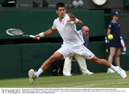 Serbia s Novak Djokovic in action during his match on day three of the 2014 Wimbledon Championships in London on June 25, 2014.  LON2014062531