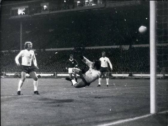 Nov. 09, 1971 - England v Switzerland European Nations Cup at Wembely: Photo show Keeper Peter Shilton punches the ball into his own goal from a shot by K Odermatt (not in picture) the Swiss indside-right watch by the England Capt Bobby Moore left and defender Madeley on right the match finished. 1-1.  - ZUMAk09