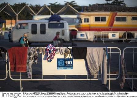 Clothings are seen hanging on the fences at the Sambadrome, in Rio de Janeiro, June 27, 2014. The world famous Sambadrome, where the famous samba parade of annual Carnival take place, were allocated to the supporters and fans of different teams, as an improvised camp site to terminate their camping at Copacabana and Ipanema beaches. 