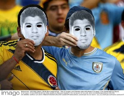Fans of Uruguay and Colombia pose with photos of Uruguay s Luis Suarez before a Round of 16 match of 2014 FIFA World Cup at the Estadio do Maracana Stadium in Rio de Janeiro on June 28, 2014.(Xinhua WangxLili)(pcy) (SP) RIO DE JANEIRO -WORLD CUP 2014 