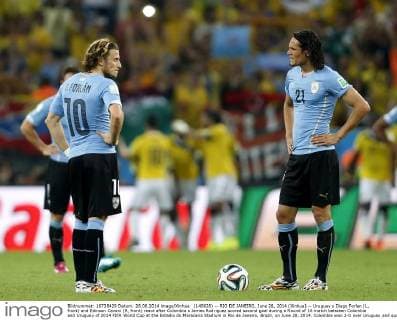 (140628) -- RIO DE JANEIRO, June 28, 2014 (Xinhua) -- Uruguay s Diego Forlan (L, front) and Edinson Cavani (R, front) react after Colombia s James Rodriguez scored second goal during a Round of 16 match between Colombia and Uruguay of 2014 FIFA World Cup at the Estadio do Maracana Stadium in Rio de Janeiro, Brazil, on June 28, 2014. Colombia won 2-0 over Uruguay and qualified for Quarter-finals on Saturday.(Xinhua Wang Lili)(pcy) (SP)BRAZIL-RIO DE JANEIRO-WORLD CUP 2014-ROUNG OF 16-COLOMBIA VS URUGUAY 