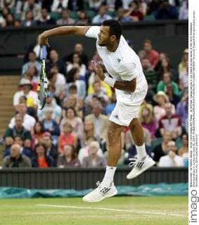 Jo Wilfried Tsonga serves in his match on day seven of the 2014 Wimbledon Championships in London on June 30, 2014.  LON2014063058