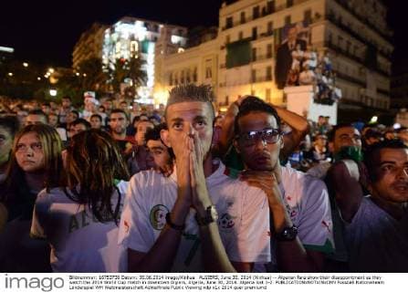 ALGIERS, June 30, 2014 (Xinhua) -- Algerian fans show their disappointment as they watch the 2014 World Cup match in downtown Algiers, Algeria, June 30, 2014. Algeria lost 1-2. 