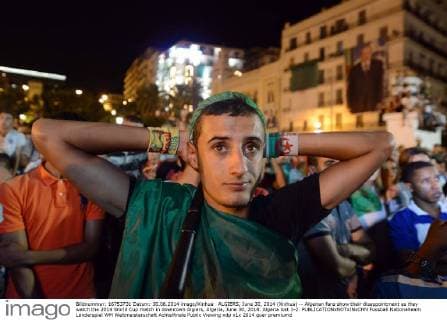 ALGIERS, June 30, 2014 (Xinhua) -- Algerian fans show their disappointment as they watch the 2014 World Cup match in downtown Algiers, Algeria, June 30, 2014. Algeria lost 1-2. 