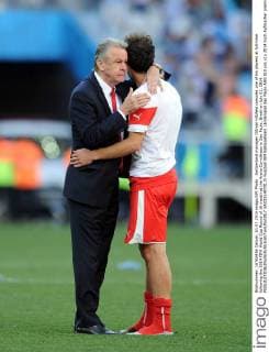 Switzerland manager Ottmar Hitzfeld consoles one of his players at full-time following the 2014 FIFA World Cup Round of 16 match at the Arena Corinthians in Sao Paulo, Brazil on July 01, 2014.  SAO2014070115