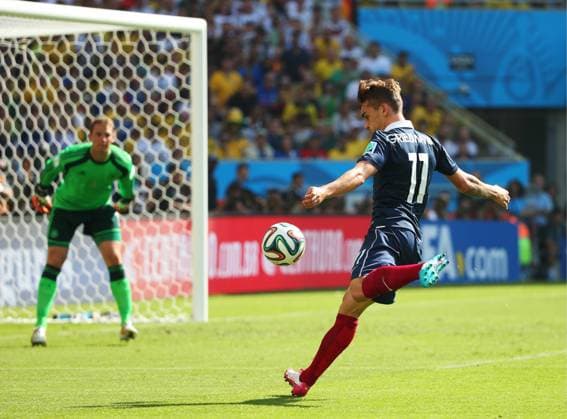 ITAR-TASS: RIO-DE-JANEIRO, BRAZIL. JULY 3, 2014. France s Antoine Griezmann (front) shoots the ball as Germany s goalkeeper Manuel Neuer looks on in their 2014 FIFA World Cup quaterfinal football match. Germany won the game 1-0.  RE1494F3