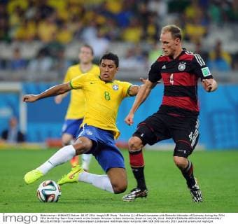 Paulinho (L) of Brazil competes with Benedikt Höwedes of Germany during the 2014 FIFA World Cup Semi Final match at the Estadio Mineirao in Belo Horizonte, Brazil on July 08, 2014.  BEL2014070810