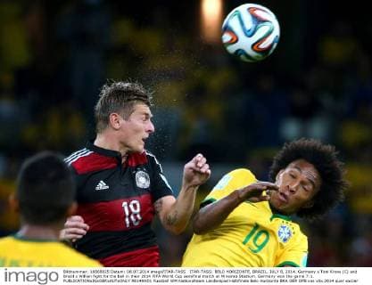 ITAR-TASS: BELO HORIZONTE, BRAZIL. JULY 8, 2014. Germany s Toni Kroos (C) and Brazil s Willian fight for the ball in their 2014 FIFA World Cup semifinal match at Mineirao Stadium. Germany won the game 7:1.  RE149AD1