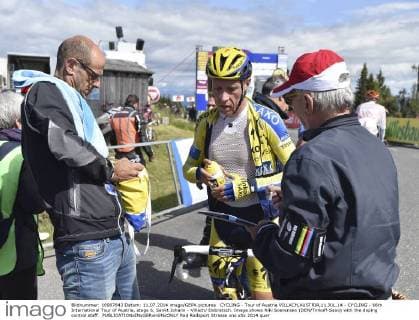 CYCLING - Tour of Austria VILLACH,AUSTRIA,11.JUL.14 - CYCLING - 66th International Tour of Austria, stage 6, Sankt Johann - Villach Dobratsch. Image shows Niki Soerensen (DEN Tinkoff-Saxo) with the doping control staff. 