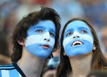 ITAR-TASS: RIO-DE-JANEIRO. JULY 13, 2014. Supporters of the Argentinian national football team with painted faces watch action in the 2014 FIFA World Cup final at Maracana Stadium.  RE14A1DF