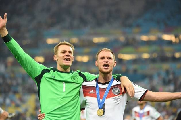Germany s Benedikt Höwedes (R) and goalkeeper Manuel NEUER celebrate their victory after the final match between Germany and Argentina of 2014 FIFA World Cup at the Estadio do Maracana Stadium in Rio de Janeiro, on July 13, 2014. 