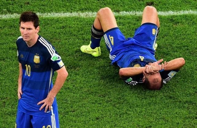 July 13, 2014 - Rio De Janeiro, BRAZIL - Argentina s Pablo Zabaleta lies on the pitch as Lionel Messi stands beside him after the World Cup final soccer match between Germany and Argentina at the Maracana Stadium in Rio de Janeiro, Brazil, Sunday, July 13, 2014. Germany defeats Argentina 1-0.  - ZUMAp12