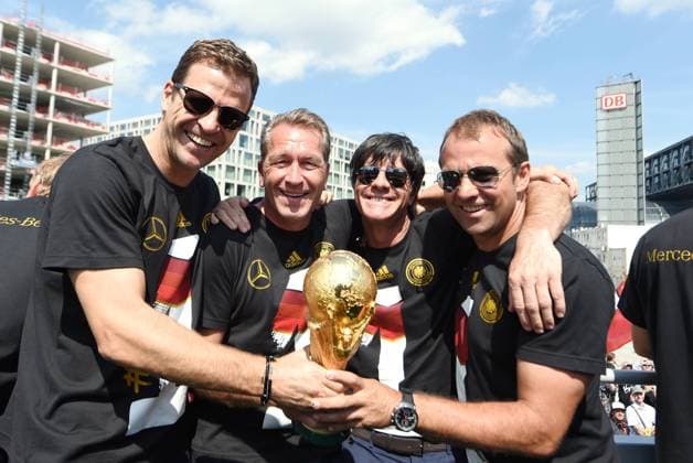 Auf dem Truck: v.l.: Oliver BIERHOFF (Deutschland Manager Nationalmannschaft), Torwarttrainer Andreas KÖPKE (Deutschland), Bundestrainer Trainer Joachim Jogi LÖW (Deutschland), Assistenztrainer Hansi FLICK (Deutschland). Empfang WM-Party Fahrt auf einem LKW Truck zur Feier der deutschen Fussball Nationalmannschaft auf die Fanmeile am Brandenburger Tor in Berlin- FIFA - Fussball Weltmeisterschaft 2014, Fanmeile Berlin, Deutschland, 15.07.2014- WC party of the german national team men- FIFA- Soccer World Cup 2014