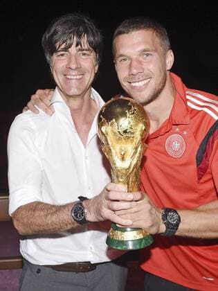 July 14, 2014 - Rio De Janeiro, BRAZIL - Germany s head coach Joachim Löw, left, and Lukas Podolski with the trophy during the party of the German soccer federation in the soccer World Cup final to win its fourth title in Rio de Janeiro, Monday morning, July 14, 2014. Germany celebrate win  - ZUMAp12