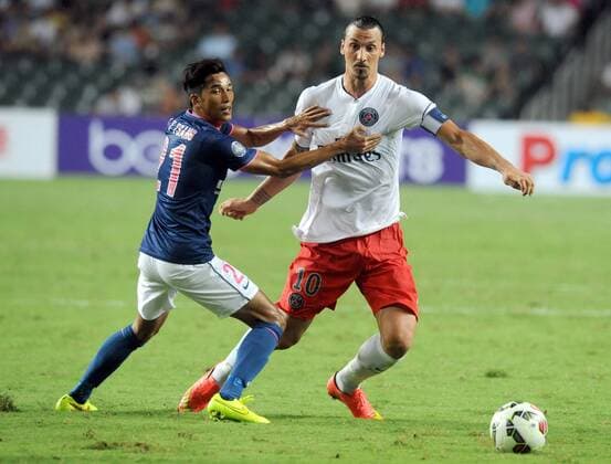 Zlatan Ibrahimovic of France s Paris Saint-Germain, right, challenges Tsang Kam To of Hong Kong s Kitchee during their friendly football match in Hong Kong, China, 29 July 2014. Zlatan Ibrahimovic scored a hat-trick on Tuesday (29 July 2014) as Paris Saint-Germain enjoyed a 6-2 victory over Hong Kong outfit Kitchee. The 32-year-old had his shooting boots working for him and was ably supported by 21-year-old Jean-Christophe Bahebeck who scored his fifth and sixth goals of the pre-season so far. PSG now travel to Beijing in China which will host this season s French Super Cup between the Ligue 1 champions and surprise French Cup winners Guingamp. Zlatan Ibrahimovic scores hat-trick, leading Paris Saint-Germain to defeate Kitchee 6-2 at Hong Kong friendly match  20140729_33299