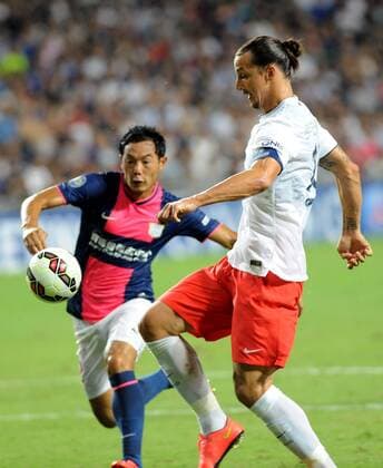 Zlatan Ibrahimovic of France s Paris Saint-Germain, right, challenges Jang Kyung-Jin of Hong Kong s Kitchee during their friendly football match in Hong Kong, China, 29 July 2014. Zlatan Ibrahimovic scored a hat-trick on Tuesday (29 July 2014) as Paris Saint-Germain enjoyed a 6-2 victory over Hong Kong outfit Kitchee. The 32-year-old had his shooting boots working for him and was ably supported by 21-year-old Jean-Christophe Bahebeck who scored his fifth and sixth goals of the pre-season so far. PSG now travel to Beijing in China which will host this season s French Super Cup between the Ligue 1 champions and surprise French Cup winners Guingamp. Zlatan Ibrahimovic scores hat-trick, leading Paris Saint-Germain to defeate Kitchee 6-2 at Hong Kong friendly match  20140729_13462