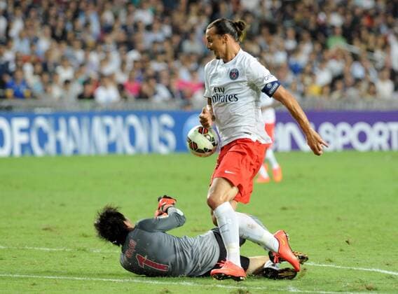 Zlatan Ibrahimovic of France s Paris Saint-Germain, front, challenges goalkeeper Wang Zhenpeng of Hong Kong s Kitchee during their friendly football match in Hong Kong, China, 29 July 2014. Zlatan Ibrahimovic scored a hat-trick on Tuesday (29 July 2014) as Paris Saint-Germain enjoyed a 6-2 victory over Hong Kong outfit Kitchee. The 32-year-old had his shooting boots working for him and was ably supported by 21-year-old Jean-Christophe Bahebeck who scored his fifth and sixth goals of the pre-season so far. PSG now travel to Beijing in China which will host this season s French Super Cup between the Ligue 1 champions and surprise French Cup winners Guingamp. Zlatan Ibrahimovic scores hat-trick, leading Paris Saint-Germain to defeate Kitchee 6-2 at Hong Kong friendly match  20140729_33300