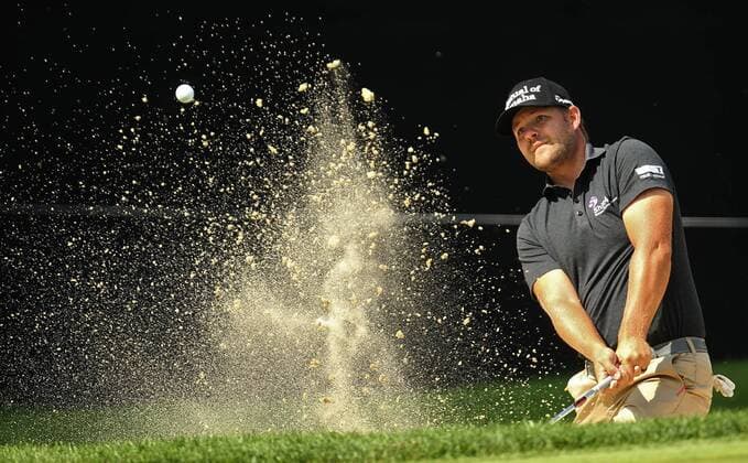 July 31, 2014 - Akron, OH, USA - Ryan Moore blasts out of a bunker on the 18th hole during the first round in the WGC-Bridgestone Invitational at Firestone Country Club in Akron, Ohio, on Thursday, July 31, 2014. WGC-Bridgestone Invitational, first round - ZUMAm67