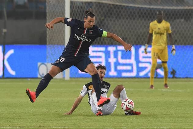 Paris Saint-Germain s Zlatan Ibrahimovic (top) competes during the match between Paris Saint-Germain and Guigamp in the French season-opening Champions Trophy football match in Beijing, China, on Aug. 2, 2014. ) (SP)CHINA-BEIJING-CHAMPIONS TROPHY GuoxYong 
