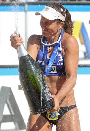 BEACH VOLLEYBALL - FIVB, Grand Slam Klagenfurt KLAGENFURT,AUSTRIA,02.AUG.14 - BEACH VOLLEYBALL - FIVB World Tour 2014, Grand Slam Klagenfurt, award ceremony. Image shows the rejoicing of Larissa Franca (BRA). Keywords: medal, trophy, champagne bottle. 