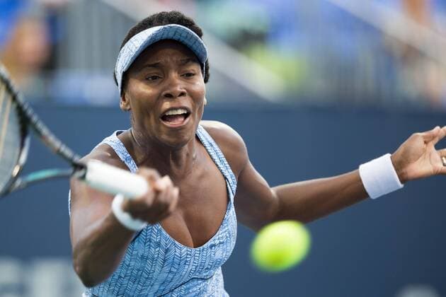 AUG 06, 2014 : Venus Williams (USA) reaches for the ball during her game in the 2nd round of the Rogers Cup presented by National Bank at Uniprix Stadium in Montreal, Quebec, Canada. TENNIS: AUG 06 Rogers Cup - woman Montreal Icon10168 EDITORIAL USE ONLY