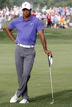 Tiger Woods waits for playing partner Phil Mickelson to hit his second shot on the opening hole during the first round of the 96th PGA Golf Herren Championship at Valhalla Country Club on August 7, 2014 in Louisville, Kentucky. This is Woods first round of golf since withdrawing from a tournament last week.  LOU2014080702