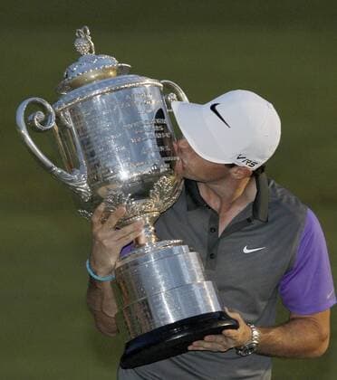 Rory McIlroy, of Northern Ireland, kisses the Wanamaker trophy after winning the 96th PGA Golf Herren Championship at Valhalla Country Club on August 10, 2014 in Louisville, Kentucky. McIlory shot 16-under-par 268 and had a one-stroke victory over Phil Mickelson.  LOU2014081019