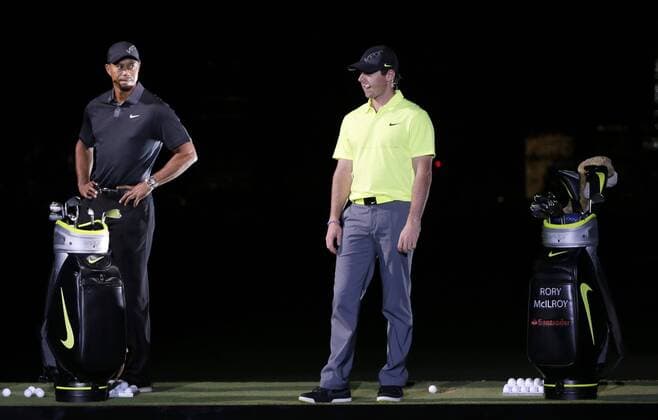 Tiger Woods stands on stage with Rory McIlroy at the launch of the new Nike Vapor Iron Franchise at Liberty National Golf Club in Jersey City, NJ on August 18, 2014. The Vapor Iron Franchise consists of 3 sets of golf club irons; The Vapor Pro, Vapor Pro Combo and Vapor Speed.  NYP20140818116