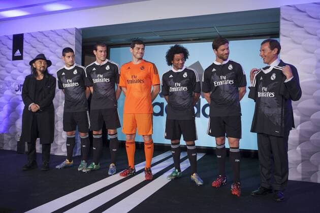 Japanese fashion designer Yohji Yamamoto, Real s James Rodriguez, Gareth Bale, Iker Casillas, Marcelo and Xabi Alonso, and Real s representative Emilio Butragueno pose for the photographers during the presentation of the Real Madrid s new Champions League kit at the Santiago Bernabeu stadium in Madrid, Spain. May 26, 2013.  (2014082621031)