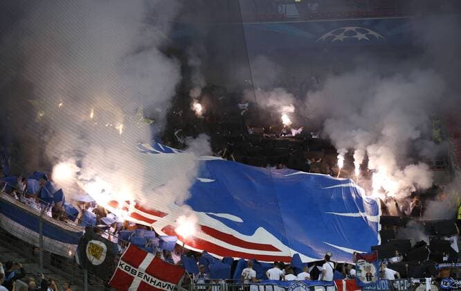 Fans of Copenhagen with bengal fire during the Championsleague Play-off match between Bayer 04 Leverkusen and FC Kopenhagen, Bayarena in Leverkusen on August 27., 2013. Bayer 04 Leverkusen vs. FC Kopenhagen in der Champions League Qualifikation der Saison 2014 2015 am 27. August 2014.