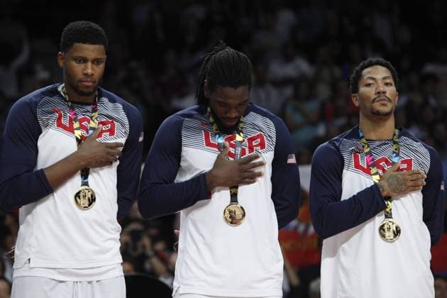 United State s Derrick Rose, Kenneth Faried and Rudy Gay listen to the national anthem with the golden medal during FIBA Basketball World Cup 2014 final award ceremony in Madrid, September 14, 2014.  (20180727)