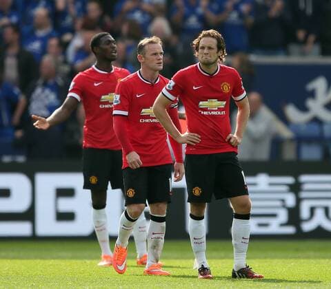 Wayne Rooney, Tyler Blackett and Daley Blind of Manchester United dejected - Barclays Premier League - Leicester City vs Manchester Utd - King Power Stadium - Leicester - England - 21st September 2014 - Picture Simon Bellis Sportimage EDITORIAL USE ONLY. No use with unauthorised audio, video, data, fixture lists, club league logos or live services. Online in-match use limited to 120 images, no video emulation. No use in betting, games or single club league player publications.
