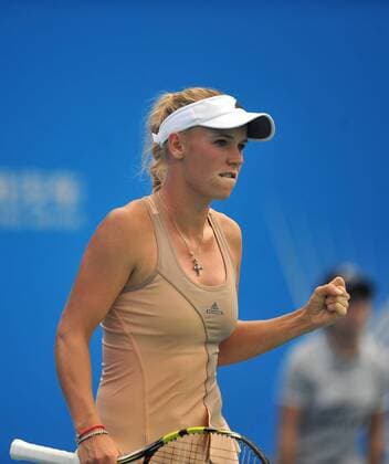 Denmark s Caroline Wozniacki jubilates during her women s singles match at the Wuhan Open tennis tournament in Wuhan, capital of central China s Hubei Province, on Sept. 23, 2014. ) (SP)CHINA-WUHAN-TENNIS-WUHAN OPEN XiaoxYijiu 
