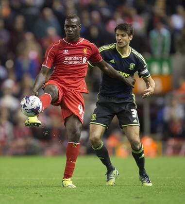 Mario Balotelli of Liverpool fends off George Friend of Middlesbrough - Liverpool vs. Middlesbrough - Capital One League Cup - Anfield - Liverpool - 23 09 2014 Pic Philip Oldham Sportimage EDITORIAL USE ONLY. No use with unauthorised audio, video, data, fixture lists, club league logos or live services. Online in-match use limited to 120 images, no video emulation. No use in betting, games or single club league player publications.
