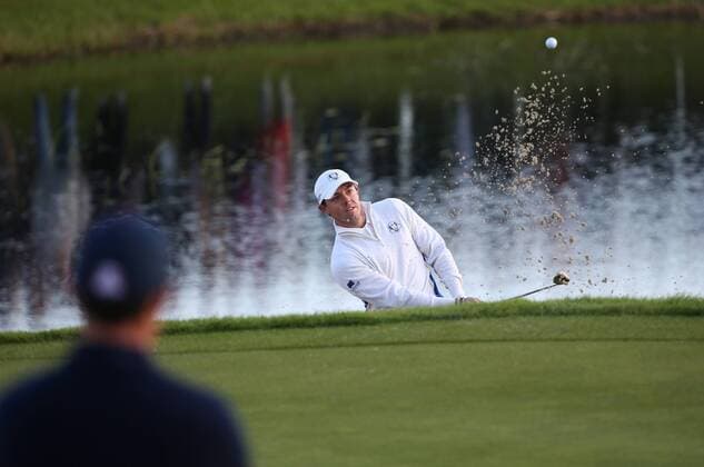 Europe s Rory McIlroy ( Mc Ilroy ) hits a ball out of the bunker in the morning fourball match against USA s Rickie Fowler and Jimmy Walker on the second day of the 2014 Ryder Cup in Gleneagles,Scotland on September 27, 2014.The match was halved.  LON2014092702