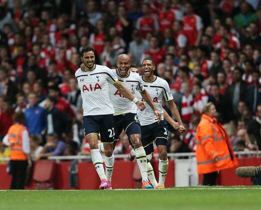 Tottenham s Nacer Chadli celebrates scoring his sides opening goal - Barclays Premier League - Arsenal vs Tottenham Hotspur - Emirates Stadium - England - 27th September 2014 - EDITORIAL USE ONLY. No use with unauthorised audio, video, data, fixture lists, club league logos or live services. Online in-match use limited to 120 images, no video emulation. No use in betting, games or single club league player publications.