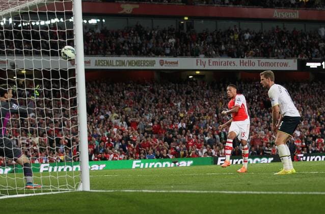 Arsenal s Alex Oxlade-Chamberlain scoring his sides opening goal - Barclays Premier League - Arsenal vs Tottenham Hotspur - Emirates Stadium - England - 27th September 2014 - EDITORIAL USE ONLY. No use with unauthorised audio, video, data, fixture lists, club league logos or live services. Online in-match use limited to 120 images, no video emulation. No use in betting, games or single club league player publications.
