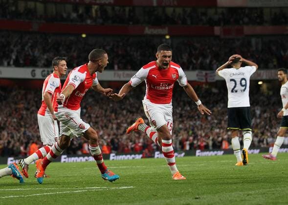 Arsenal s Alex Oxlade-Chamberlain celebrates scoring his sides opening goal - Barclays Premier League - Arsenal vs Tottenham Hotspur - Emirates Stadium - England - 27th September 2014 - EDITORIAL USE ONLY. No use with unauthorised audio, video, data, fixture lists, club league logos or live services. Online in-match use limited to 120 images, no video emulation. No use in betting, games or single club league player publications.