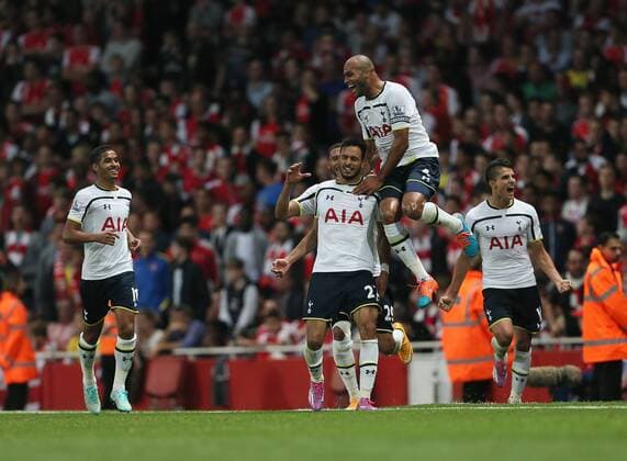 Tottenham s Nacer Chadli celebrates scoring his sides opening goal - Barclays Premier League - Arsenal vs Tottenham Hotspur - Emirates Stadium - England - 27th September 2014 - EDITORIAL USE ONLY. No use with unauthorised audio, video, data, fixture lists, club league logos or live services. Online in-match use limited to 120 images, no video emulation. No use in betting, games or single club league player publications.