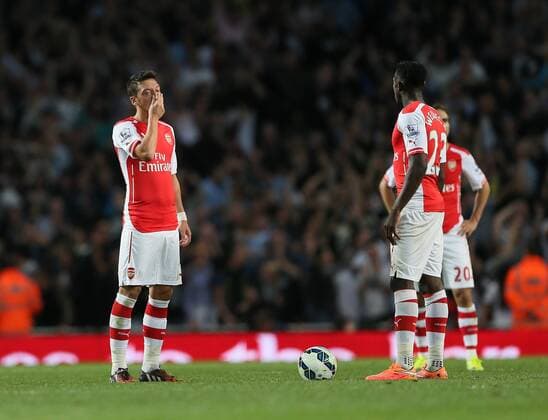 Arsenal s Mesut Ozil looks on dejected after going 1-0 down - Barclays Premier League - Arsenal vs Tottenham Hotspur - Emirates Stadium - England - 27th September 2014 - EDITORIAL USE ONLY. No use with unauthorised audio, video, data, fixture lists, club league logos or live services. Online in-match use limited to 120 images, no video emulation. No use in betting, games or single club league player publications.