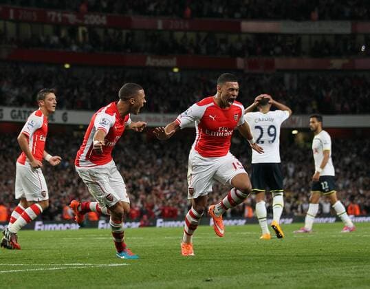 Arsenal s Alex Oxlade-Chamberlain celebrates scoring his sides opening goal - Barclays Premier League - Arsenal vs Tottenham Hotspur - Emirates Stadium - England - 27th September 2014 - EDITORIAL USE ONLY. No use with unauthorised audio, video, data, fixture lists, club league logos or live services. Online in-match use limited to 120 images, no video emulation. No use in betting, games or single club league player publications.