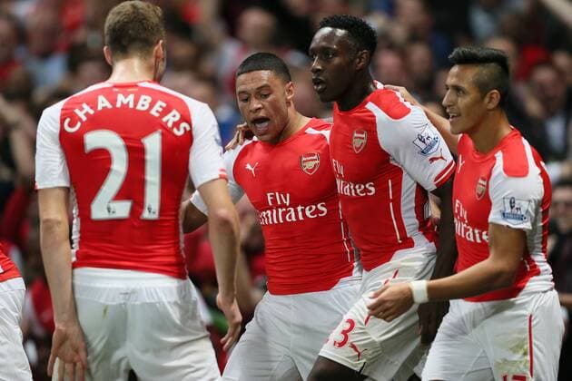 Arsenal s Alex Oxlade-Chamberlain celebrates scoring his sides opening goal - Barclays Premier League - Arsenal vs Tottenham Hotspur - Emirates Stadium - England - 27th September 2014 - EDITORIAL USE ONLY. No use with unauthorised audio, video, data, fixture lists, club league logos or live services. Online in-match use limited to 120 images, no video emulation. No use in betting, games or single club league player publications.