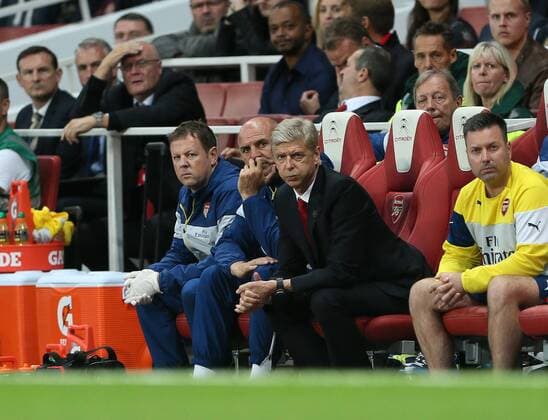 Arsenal s Arsene Wenger looks on - Barclays Premier League - Arsenal vs Tottenham Hotspur - Emirates Stadium - England - 27th September 2014 - EDITORIAL USE ONLY. No use with unauthorised audio, video, data, fixture lists, club league logos or live services. Online in-match use limited to 120 images, no video emulation. No use in betting, games or single club league player publications.